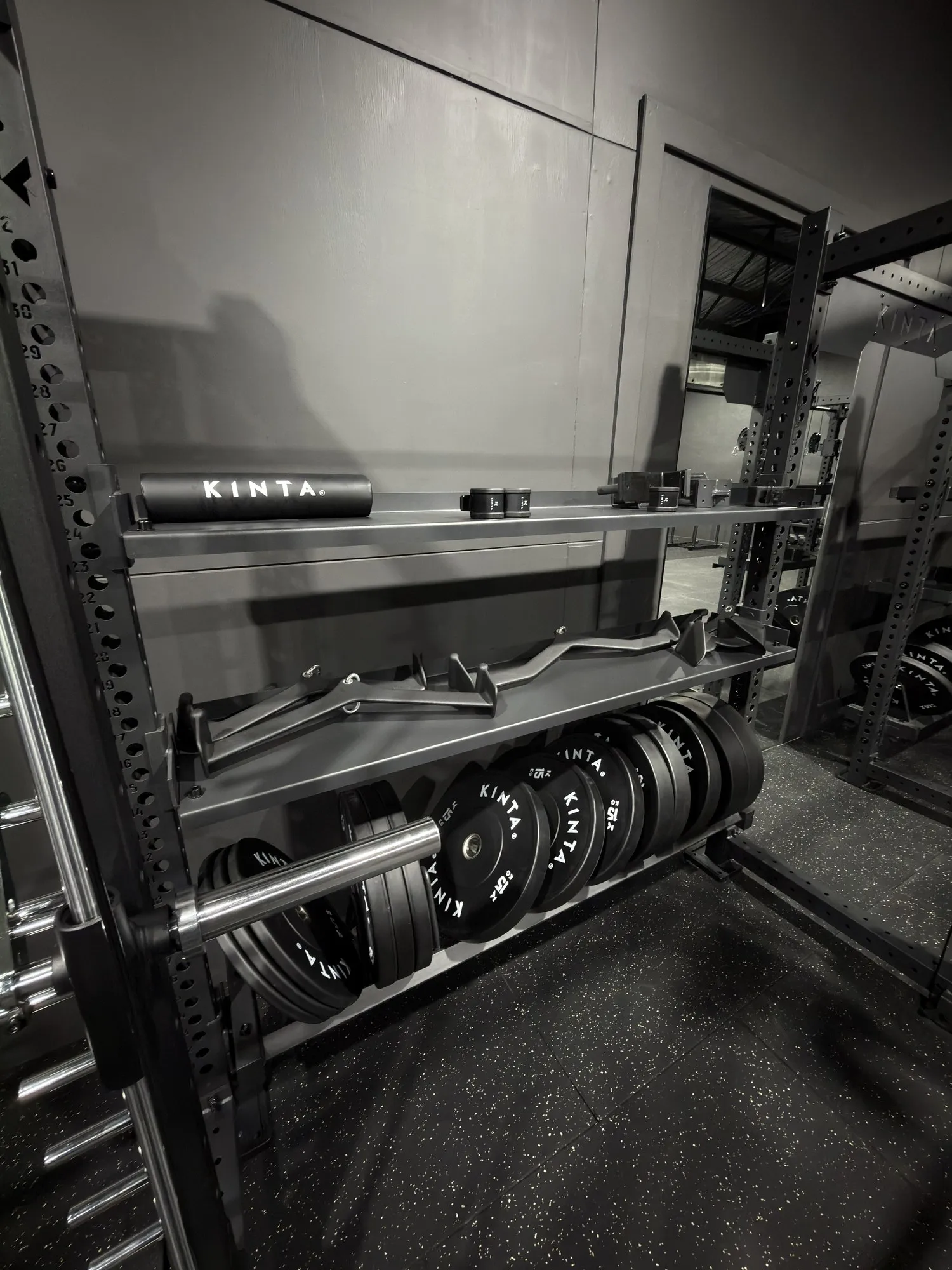 Weight racks in the Olympus Lifestyle Co training space